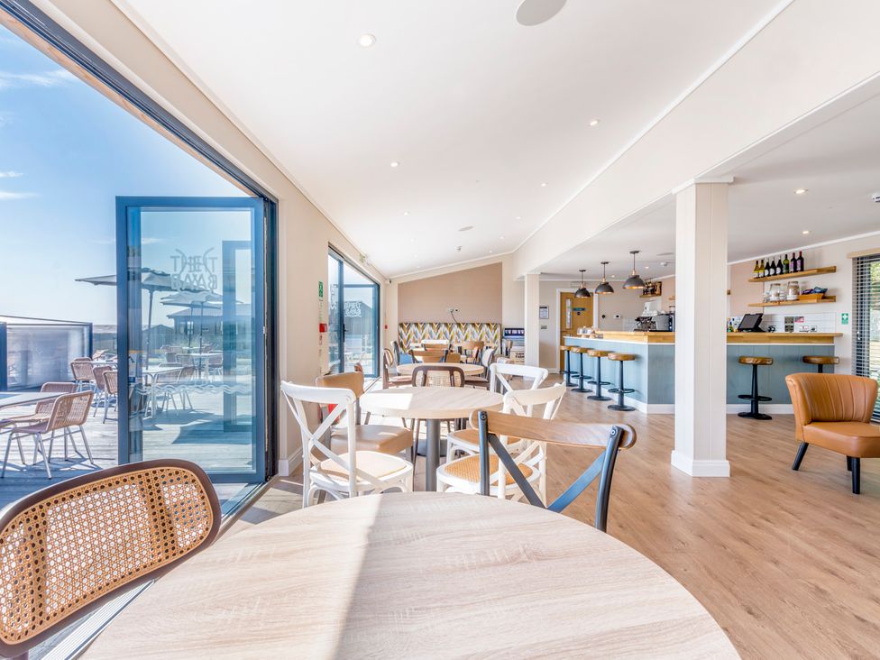 A dining area with tables and chairs at Lodge 68 at Riviera Bay Coastal Retreat Brixham