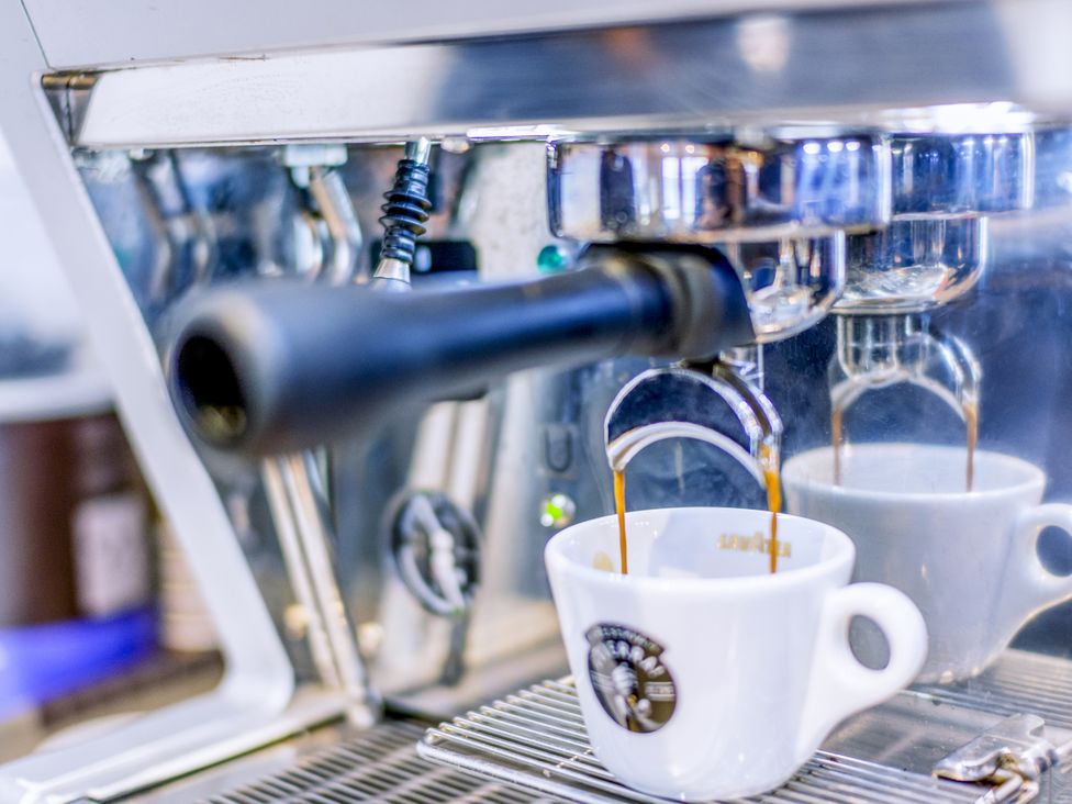 An espresso machine brewing coffee at Lodge 70 at Riviera Bay Coastal Retreat in Brixham