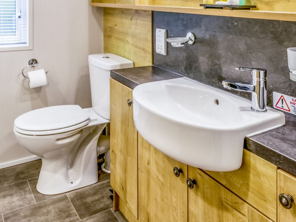 A bathroom with a sink and toilet at Lodge 72 at Riviera Bay Coastal Retreat Brixham