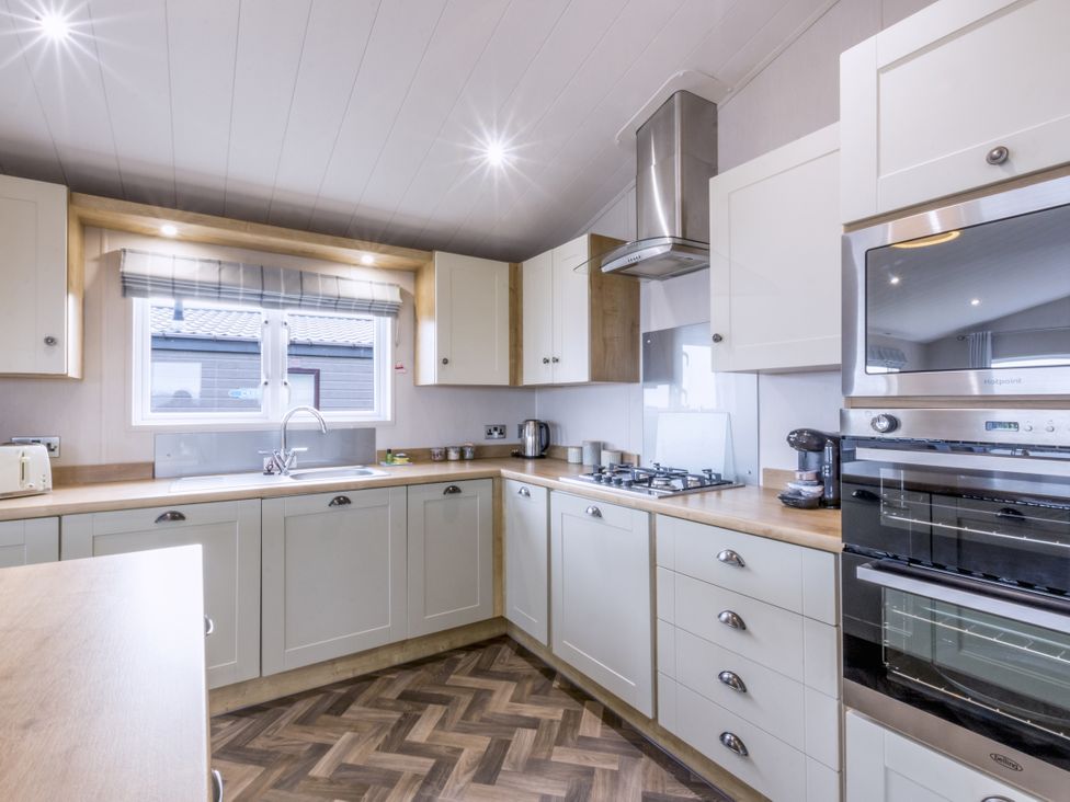 A kitchen with countertops and appliances at Lodge 73 at Riviera Bay Coastal Retreat Brixham