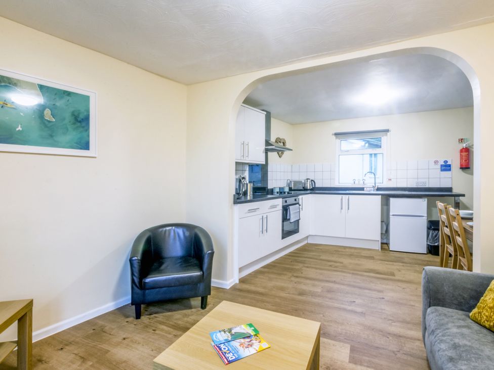 A kitchen area with a sink and stove at Chalet 31 at Landscove Holiday Park Brixham
