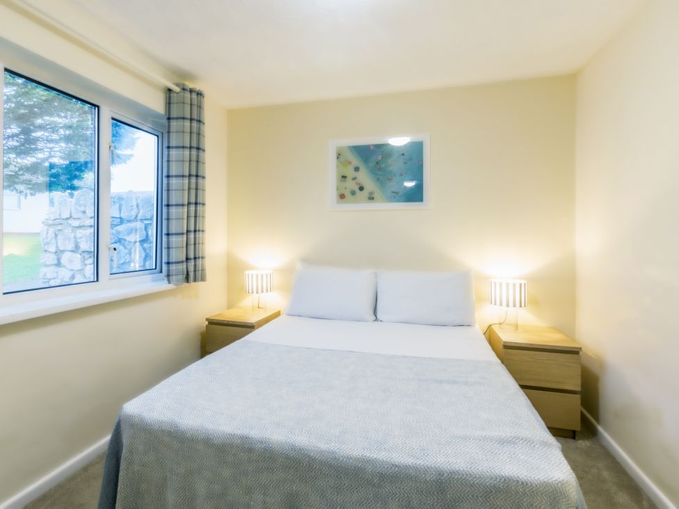 A bedroom with a bed and bedside table at Chalet 15 at Landscove Holiday Park Brixham