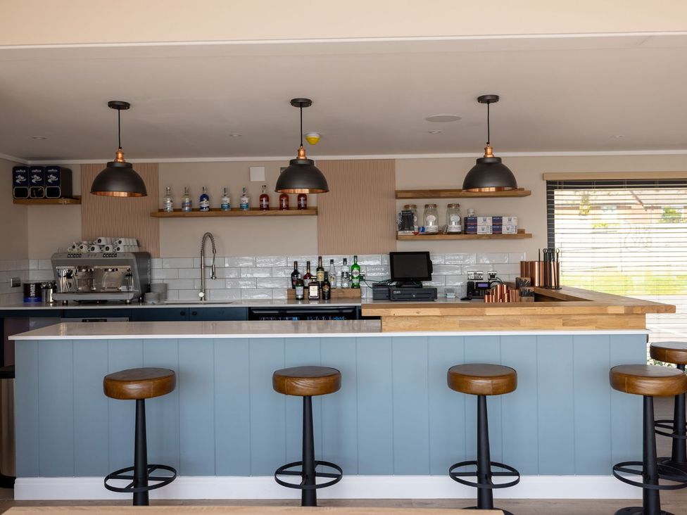 A kitchen bar area with stools at Chalet 33 at Landscove Holiday Park Brixham