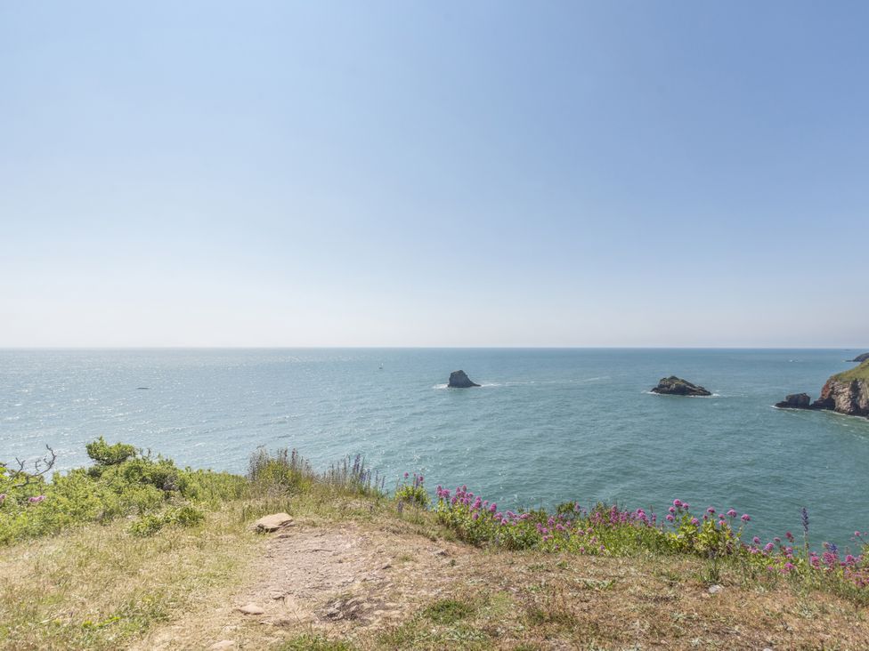 A scenic view of the ocean with rock formations at Lodge 11 at Landscove Holiday Park Brixham