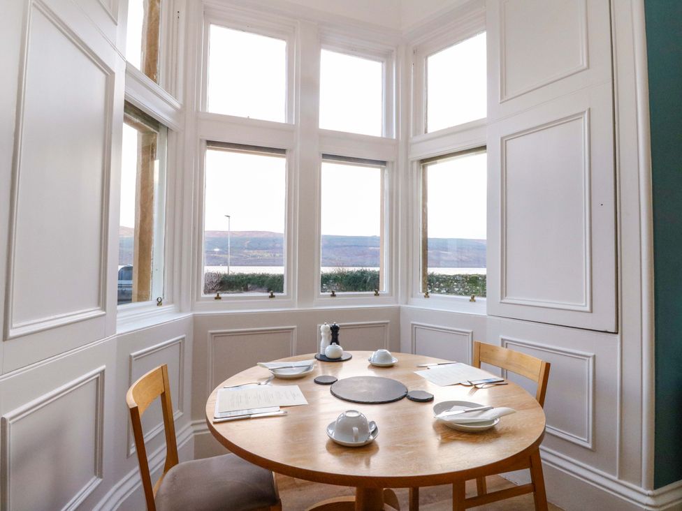 A dining room with a table set for a meal at Rudha Na Craig in Inveraray