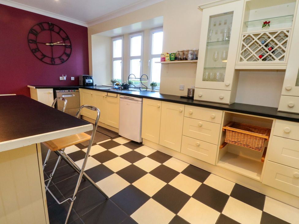 A kitchen with a countertop and stools at Rudha Na Craig in Inveraray
