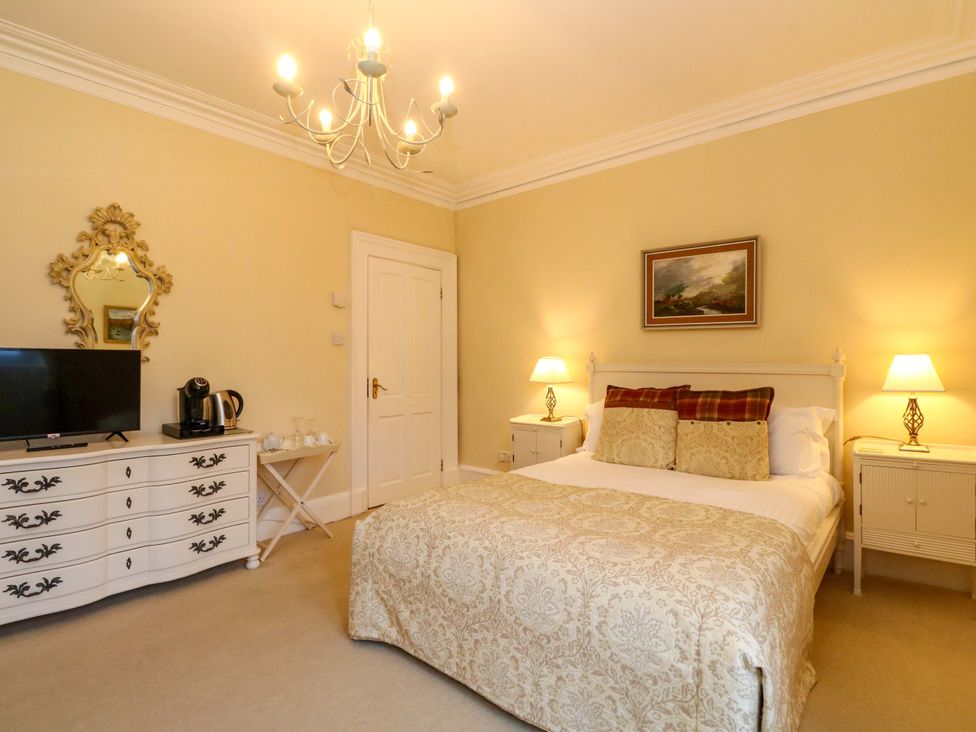 A bedroom with a bed and television at Rudha Na Craig Inveraray