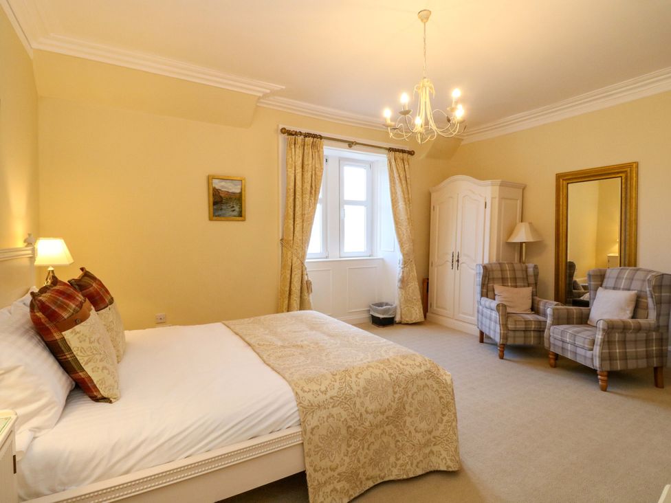 A bedroom with bed and armchairs at Rudha Na Craig in Inveraray