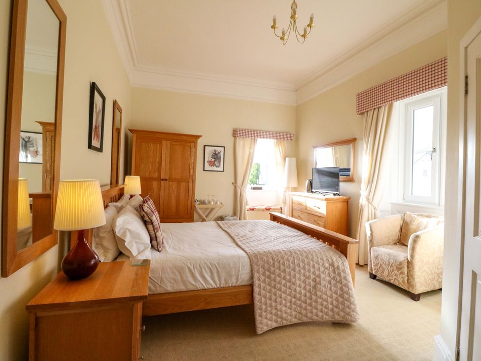 A bedroom with a bed, nightstand, and television at Rudha Na Craig in Inveraray