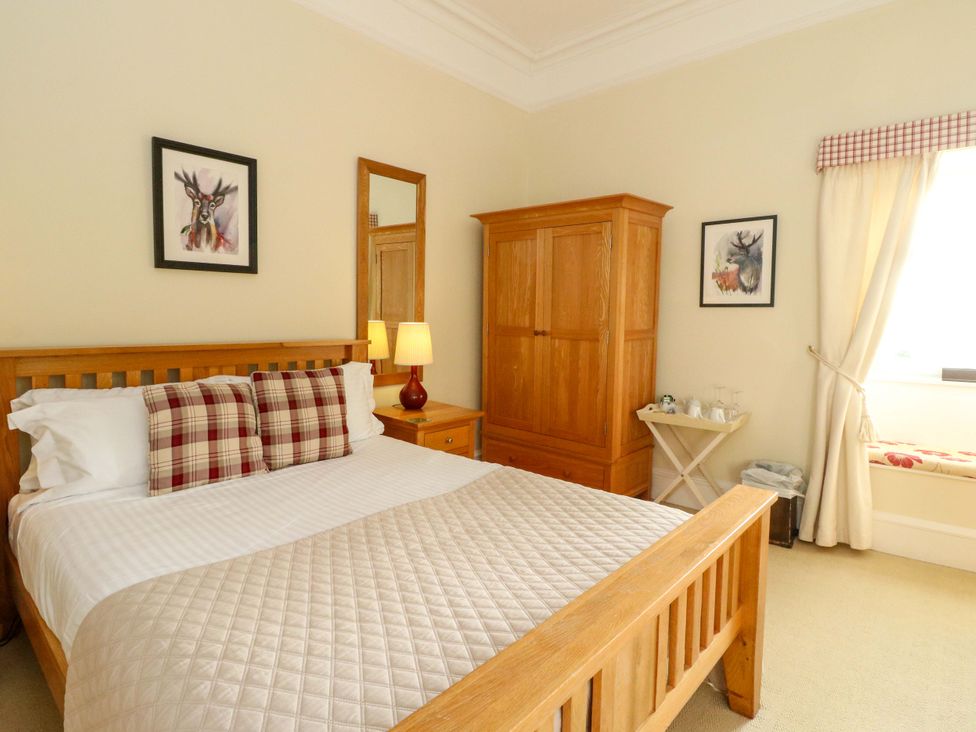A bedroom with a bed and wardrobe at Rudha Na Craig in Inveraray