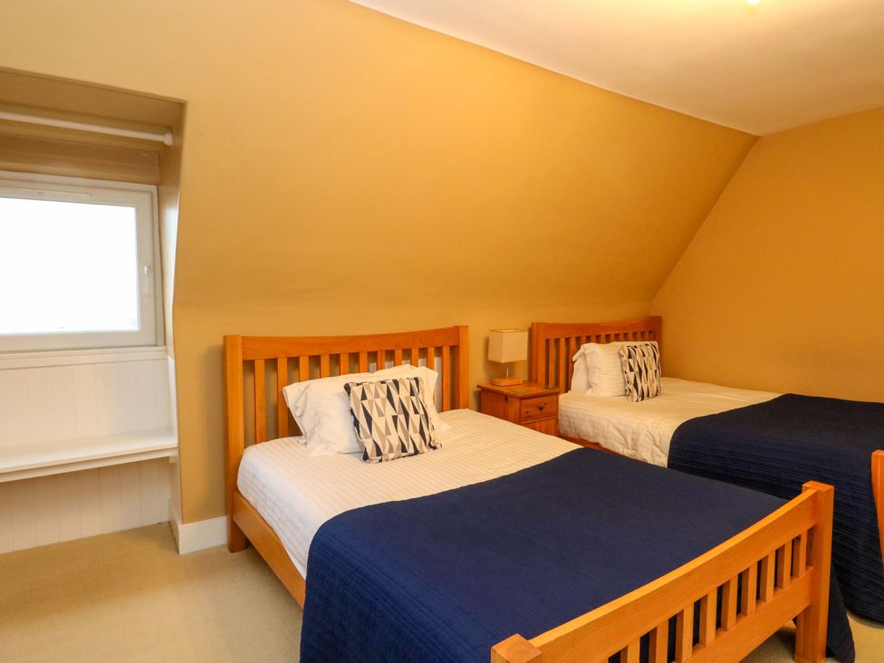 A bedroom with two beds and a window at Rudha Na Craig in Inveraray