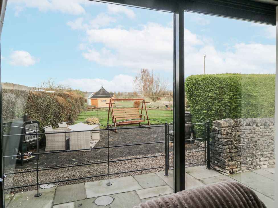 A garden view with a swing and outdoor furniture at 1 Gilpin House Levens