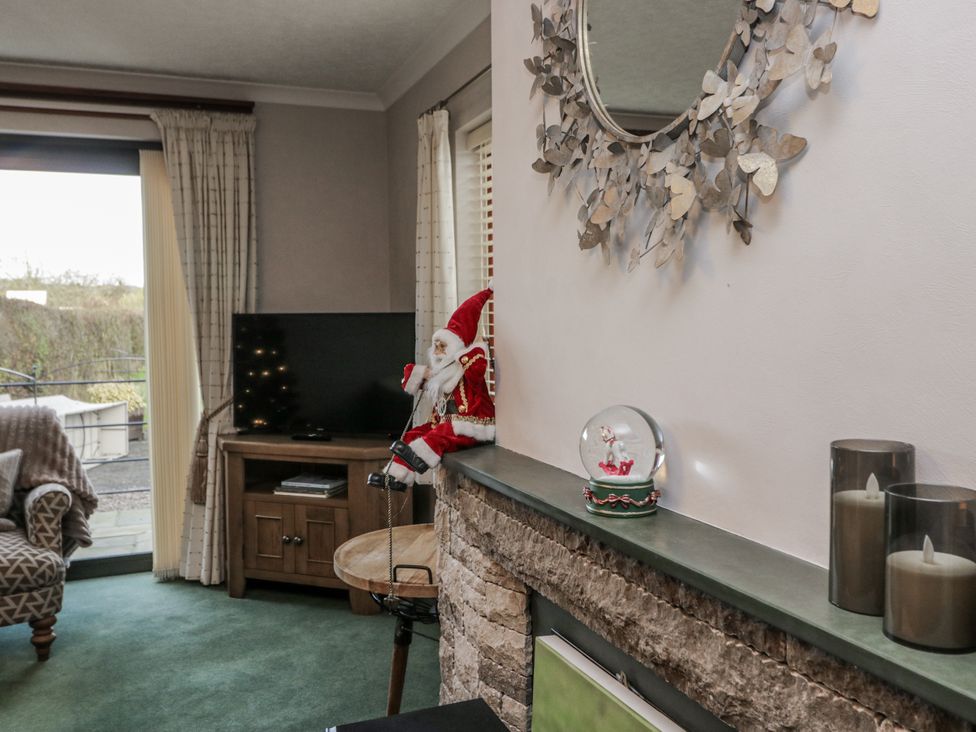 A living room with a sofa and television at 1 Gilpin House Levens