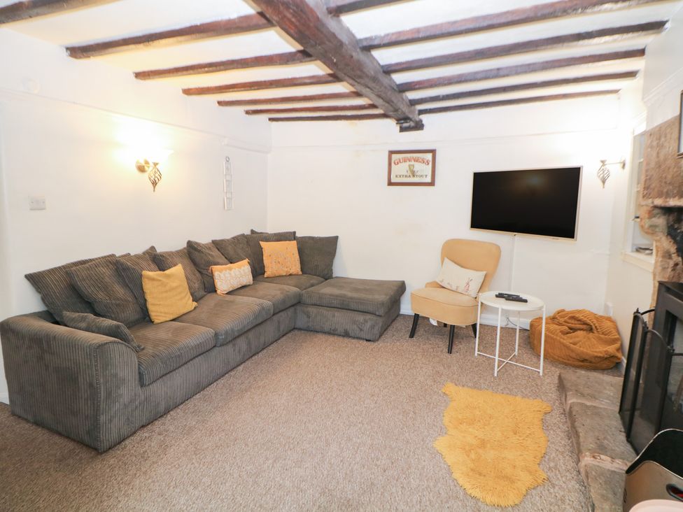 A living room with a sofa and television at Roseville in Cromford