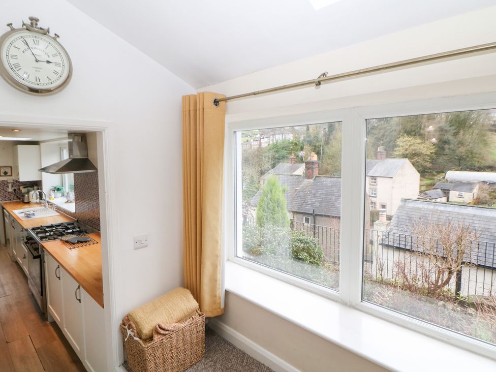 A kitchen with a view of the outdoors and wooden countertops at Roseville in Cromford