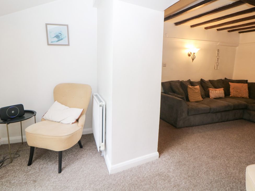 A living room with an armchair and sofa at Roseville in Cromford