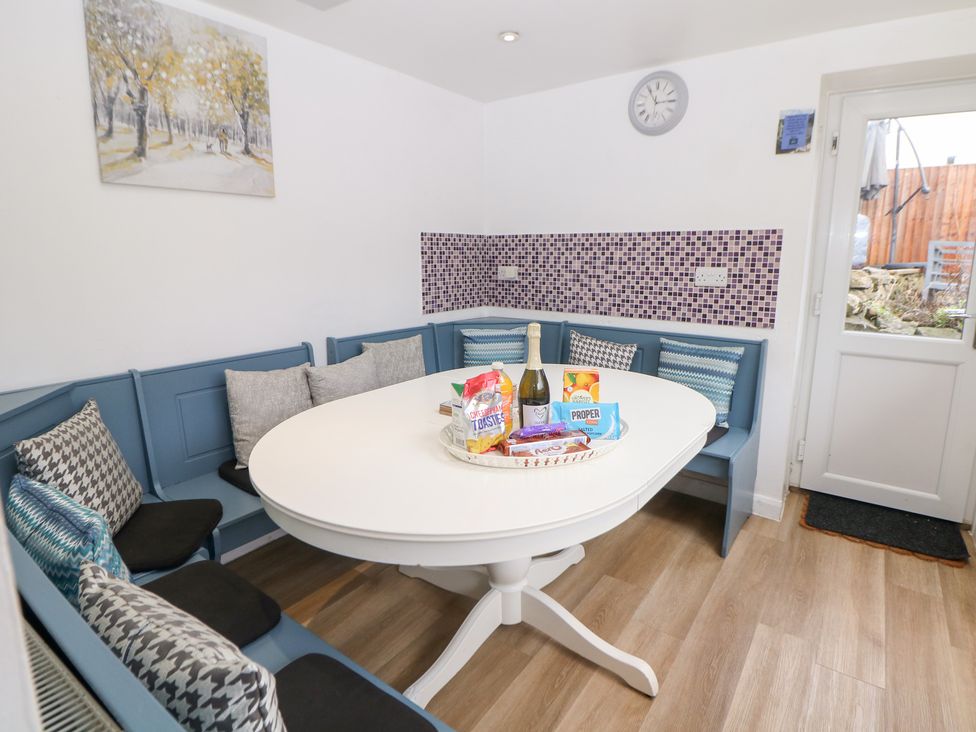 A dining room with a table and chairs at Roseville in Cromford