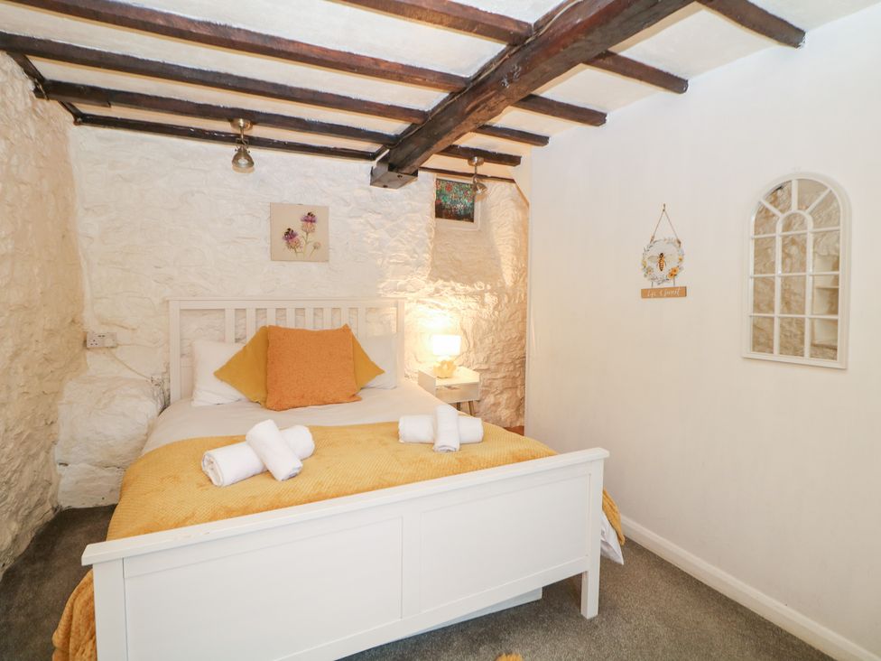 A bedroom with a bed and a lamp at Roseville in Cromford