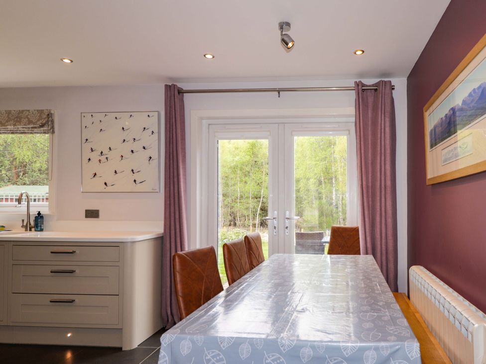 A kitchen with a table and chairs at 6 Carn Dearg in Aviemore