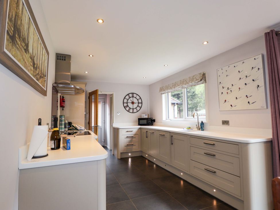 A kitchen with cabinets and appliances at 6 Carn Dearg in Aviemore