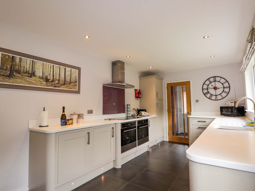 A kitchen with appliances and artwork at 6 Carn Dearg in Aviemore