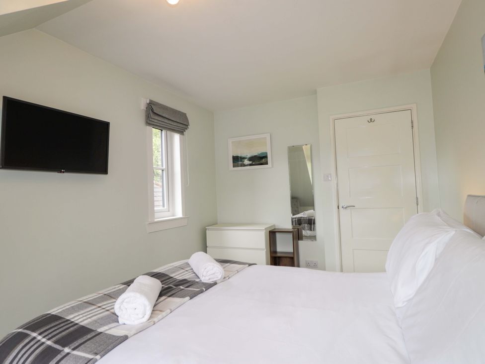 A bedroom with a bed and television at 6 Carn Dearg in Aviemore