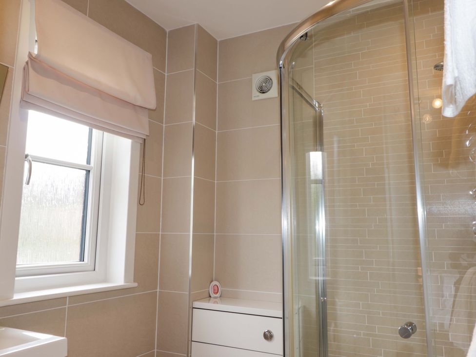 A bathroom with a shower and a window at 6 Carn Dearg in Aviemore