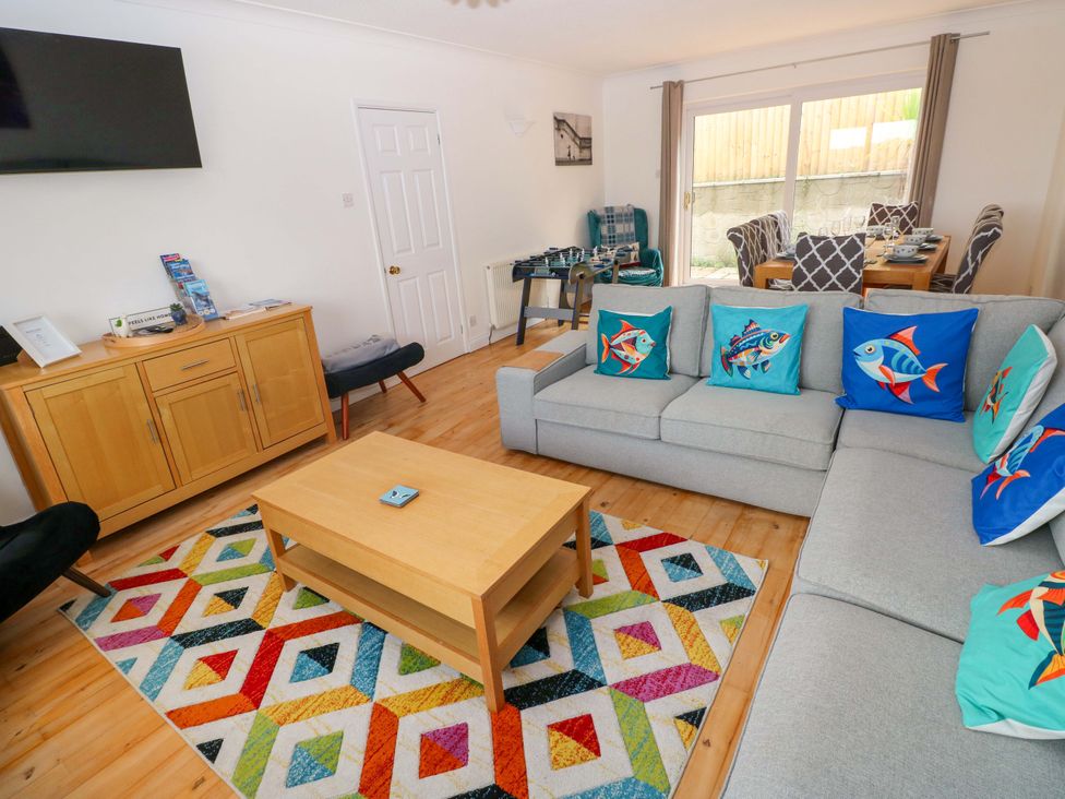 A living room with a sofa and coffee table at 15 Lawnswood in Saundersfoot