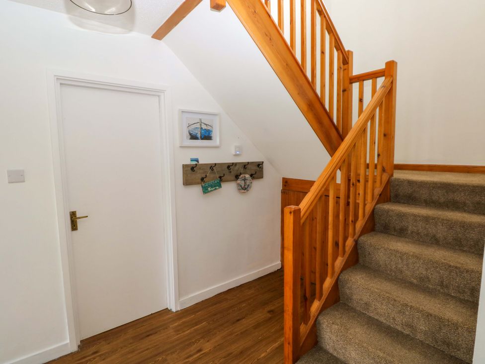 A staircase leading to an upper level in the hallway at 15 Lawnswood Saundersfoot