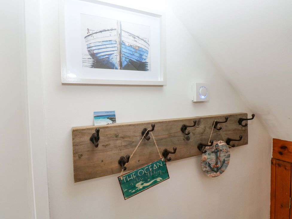 A corridor with wall hooks and a photograph at 15 Lawnswood Saundersfoot