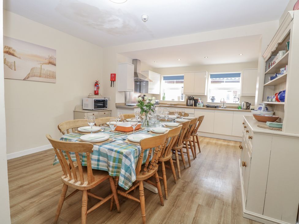 A dining area with a table set for dinner at Beach House in Winterton-On-Sea
