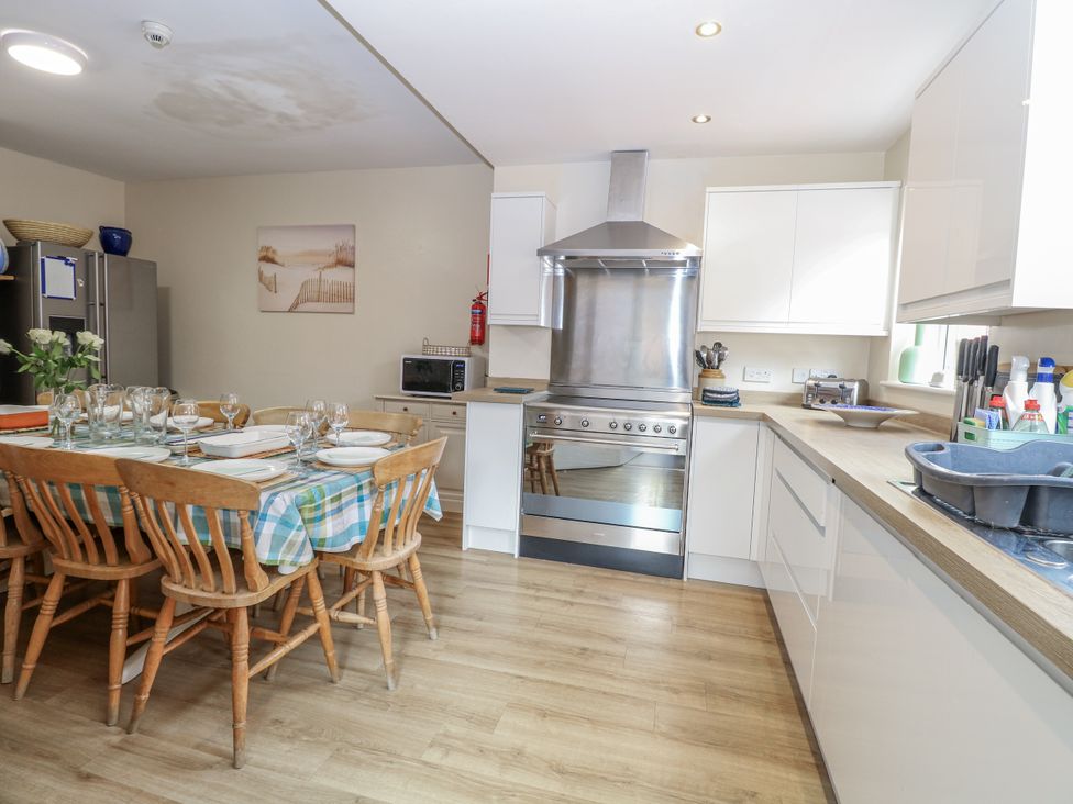 A kitchen with a dining table and chairs at Beach House in Winterton-On-Sea