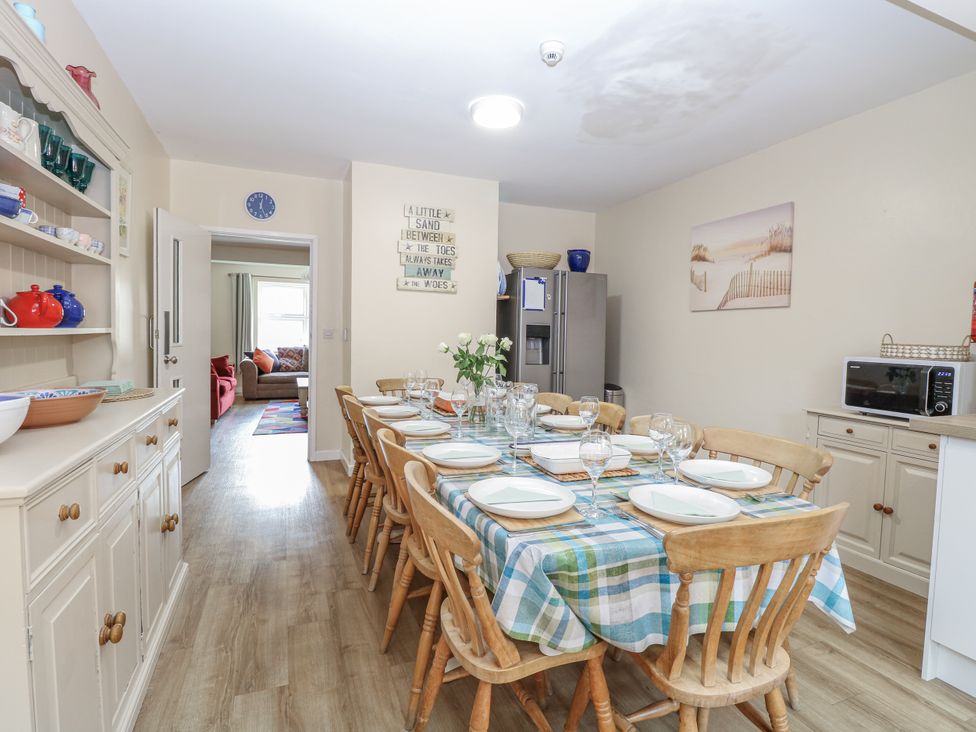 A dining room with a table set for dinner at Beach House Winterton-On-Sea