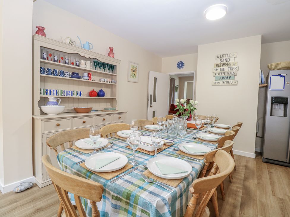 A dining room with a table set for a meal at Beach House Winterton-On-Sea