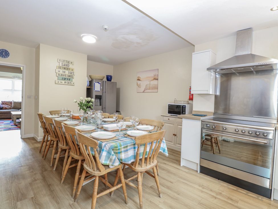 A kitchen with a dining table and chairs at Beach House in Winterton-On-Sea