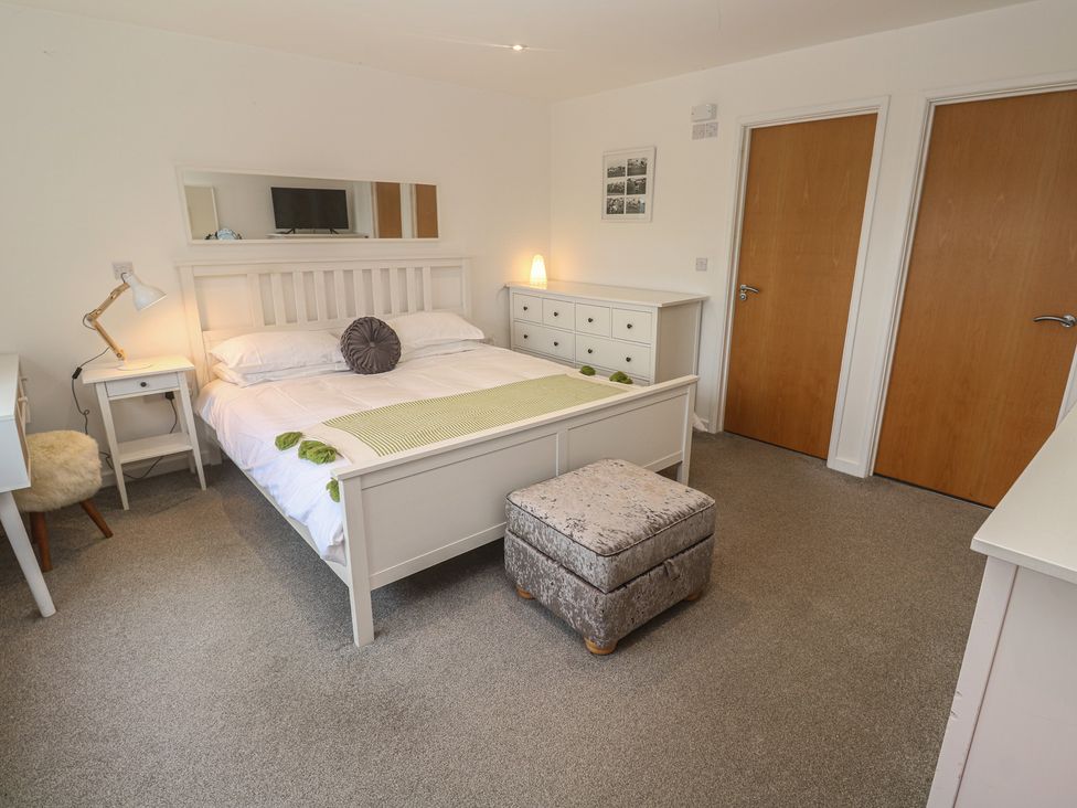 A bedroom with a bed and nightstand at Chy Holly in Carbis Bay