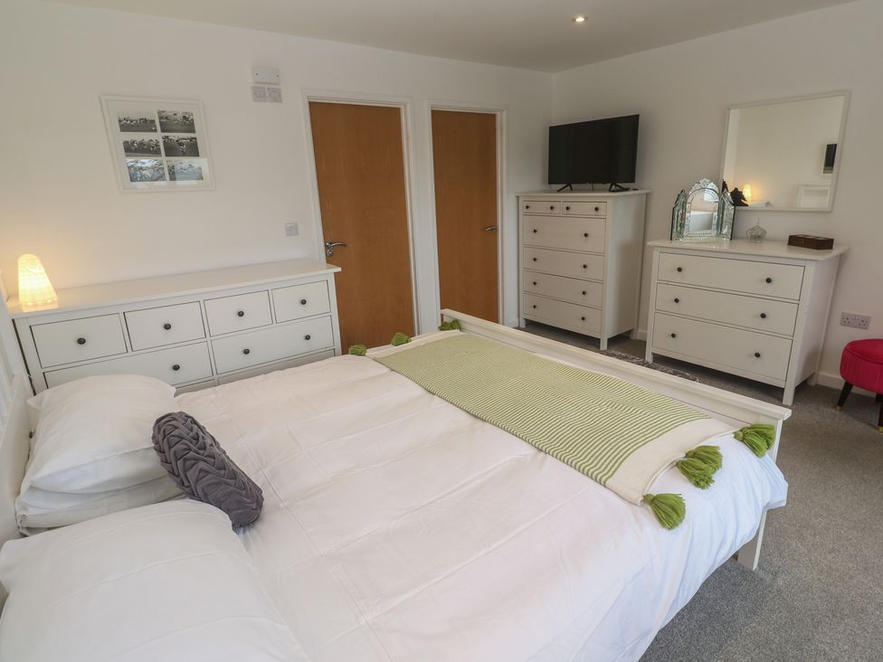 A bedroom with a bed and dressers at Chy Holly in Carbis Bay