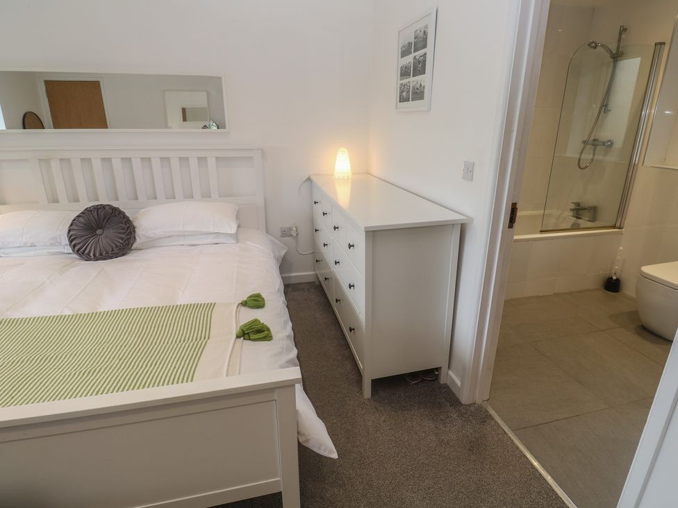 A bedroom with a bed and attached bathroom at Chy Holly in Carbis Bay