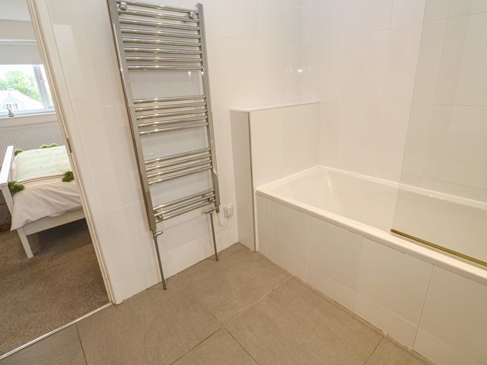 A bathroom with a bathtub and towel rail at Chy Holly in Carbis Bay