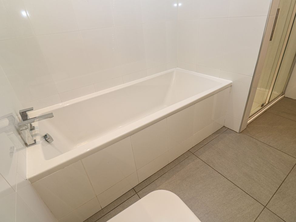 A bathroom with a bathtub and shower at Chy Holly in Carbis Bay