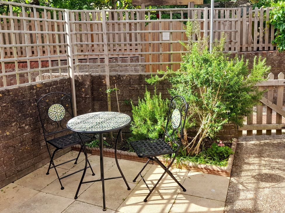 A garden with a table and two chairs at Old Ropemakers Cottage in Bridport