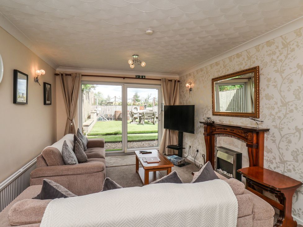 A living room with a television and fireplace at Sea Roke in Filey
