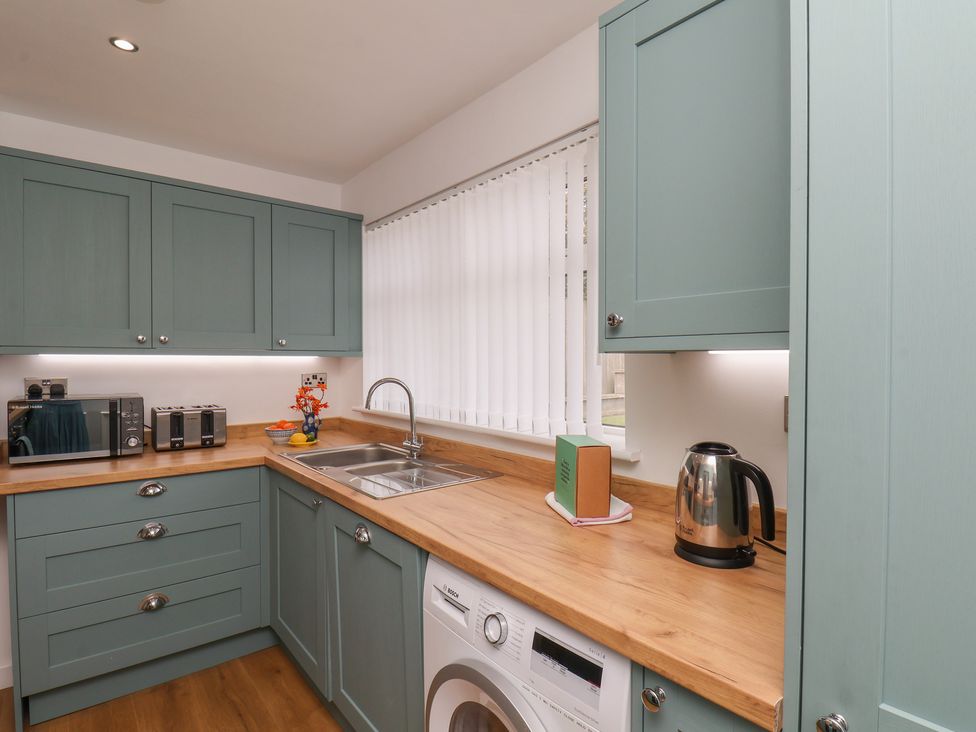 A kitchen with a sink and appliances at Sea Roke in Filey