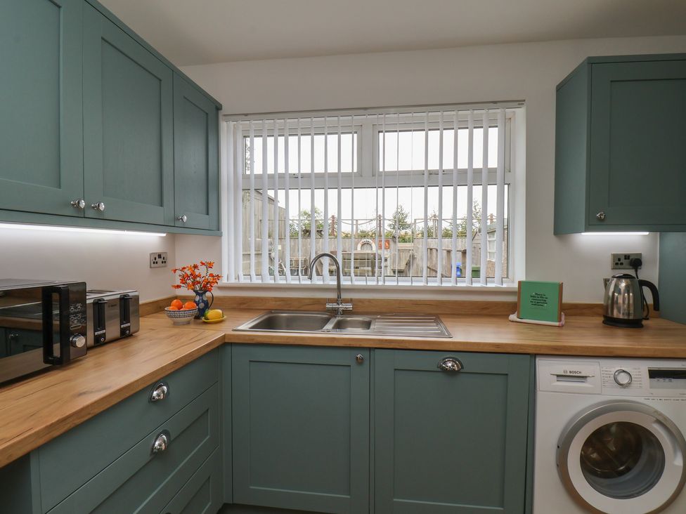 A kitchen with a sink and appliances at Sea Roke in Filey