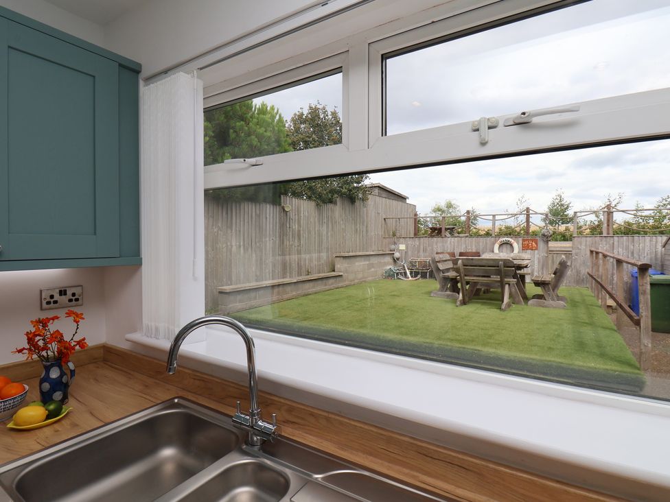 A kitchen sink with a view of the garden at Sea Roke in Filey