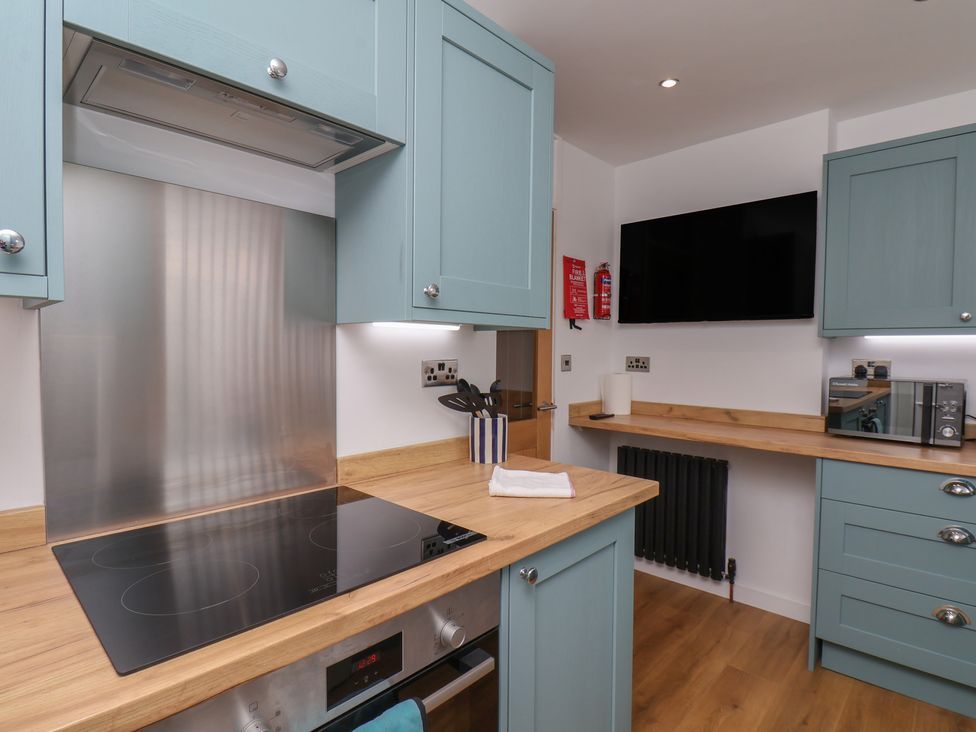 A kitchen with cabinets and appliances at Sea Roke in Filey
