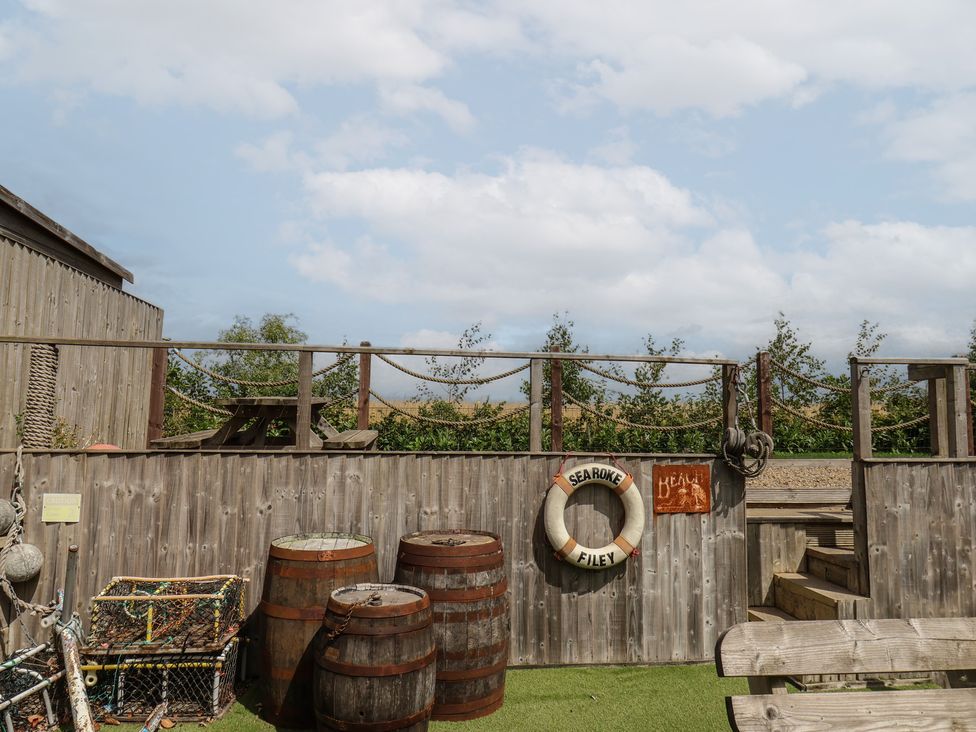 An outdoor area with barrels and a lifebuoy at Sea Roke in Filey