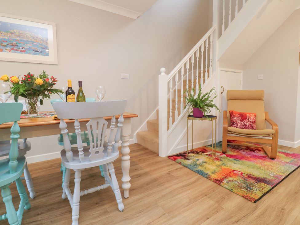 A dining room with a table and chairs at Jaspers Retreat, formerly known as Starfish Cottage in Falmouth
