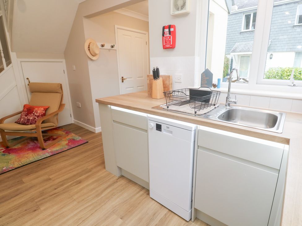 A kitchen with a sink and dishwasher at Jaspers Retreat, formerly known as Starfish Cottage, Falmouth