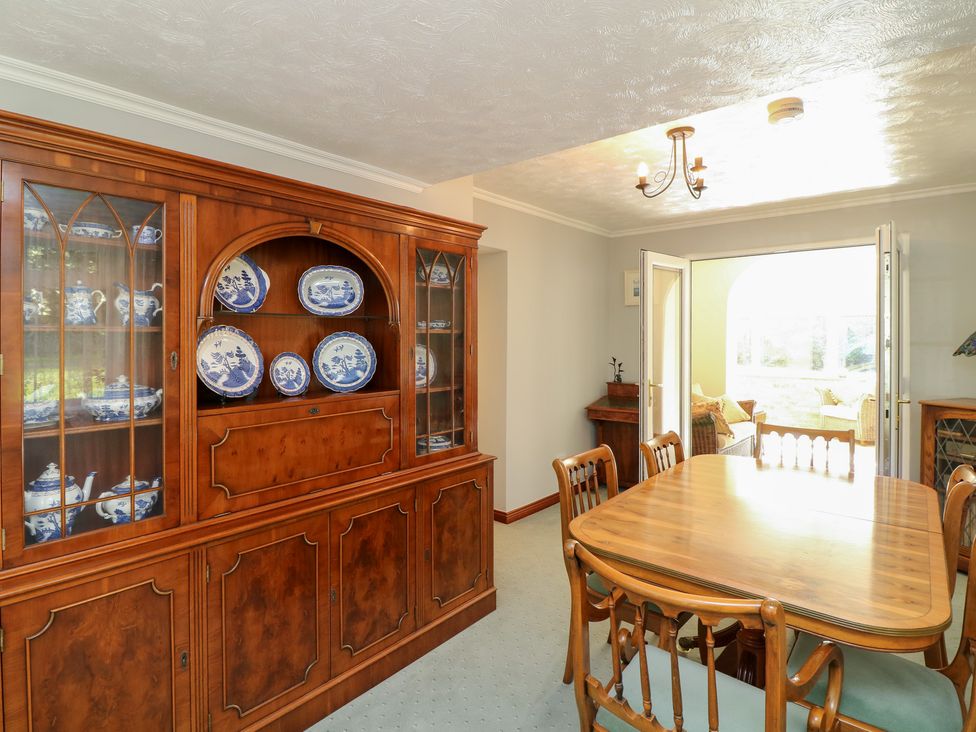 A dining room with a sideboard and dining table at Larkspur Cottage Alford